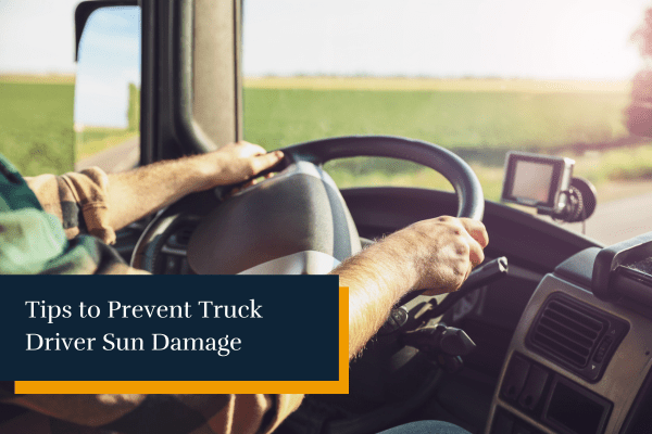truck driver with hands on the steering wheel exposed to the sun